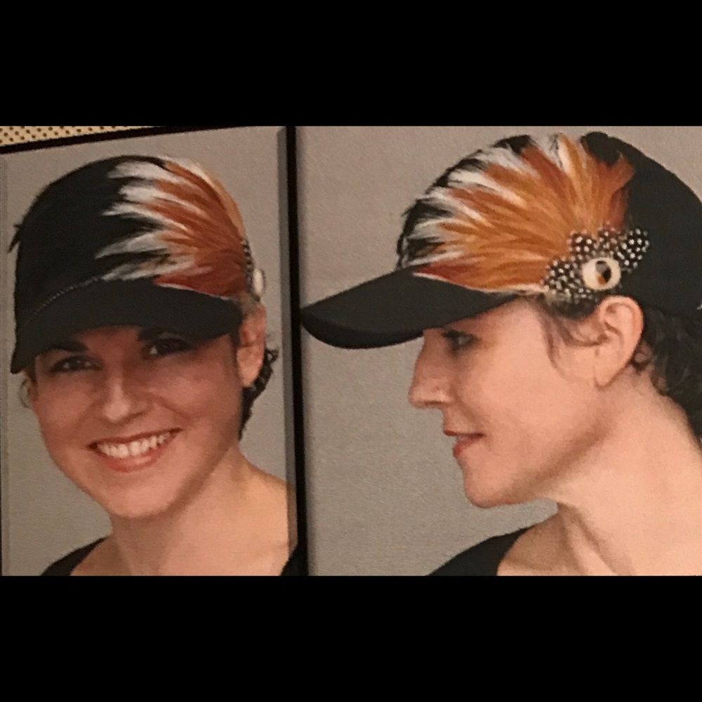 Black ball cap with brown/white/black feathers
